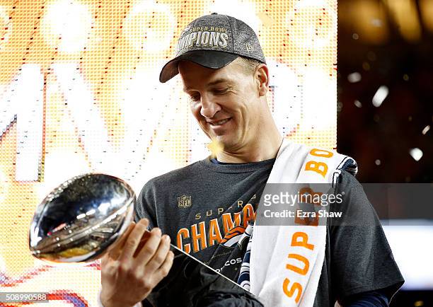 Peyton Manning of the Denver Broncos looks at the Vince Lombardi Trophy after Super Bowl 50 at Levi's Stadium on February 7, 2016 in Santa Clara,...
