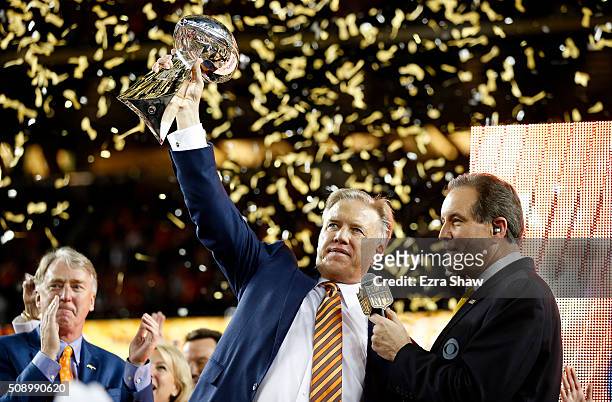 Denver Broncos general manager John Elway holds up the Vince Lombardi Trophy after defeating the Carolina Panthers during Super Bowl 50 at Levi's...