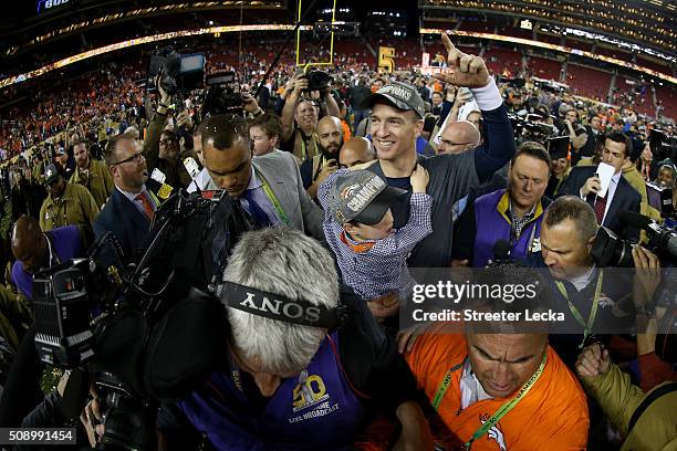 Peyton Manning of the Denver Broncos holds his son Marshall after the Denver Broncos defeated the Carolina Panthers with a score of 24 to 10 to win...