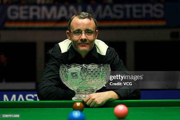 Martin Gould of England poses with the trophy as he wins during the final match against Luca Brecel of Belgium on day five of German Masters 2016 at...