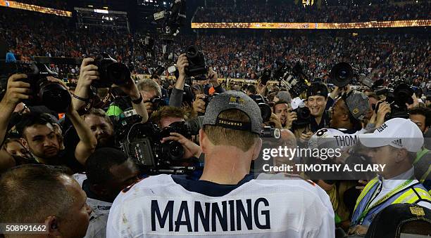 Quarterback Peyton Manning of the Denver Broncos is surrounded by the media following victory over the Carolina Panthers in Super Bowl 50 at Levi's...