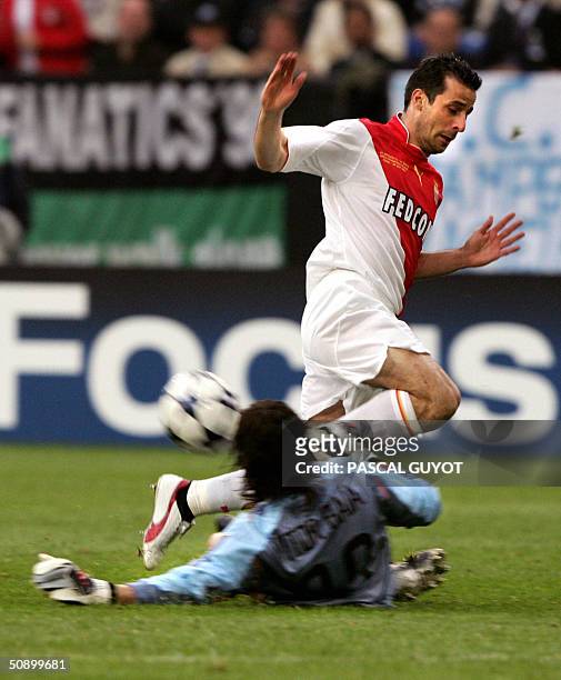Germany: Monaco's captain Ludovic Giuly jumps over Porto's goalkeeper Vitor Baia during the Champions League final football match, 26 May 2004 at the...