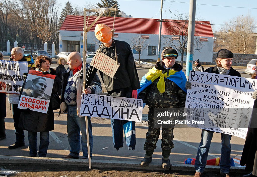 Activists stand with a mannequin depicting President of...