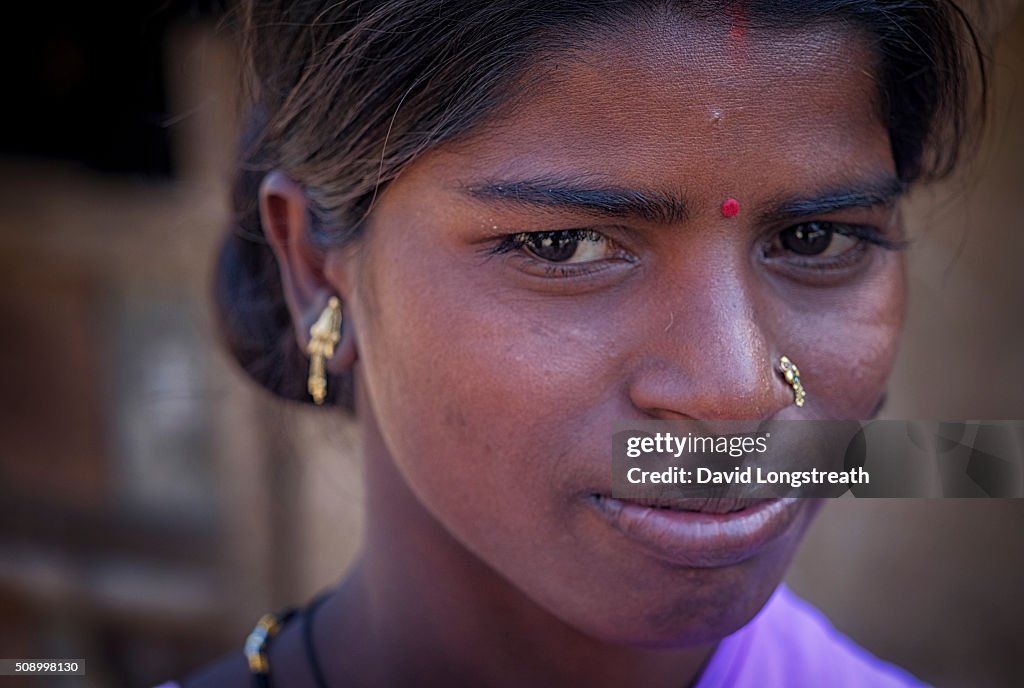 An Indian woman from a poor rural village looks on...