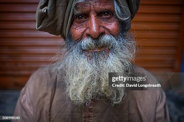 Hindu wandering holy man, known as a Sadhu, looks on from one of many religious shrines on the Ganges river. Throughout India, Sadhus practices a...