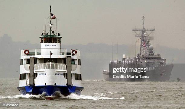 Circle Line tour boat passes as the USS DeWert sails through New York Harbor during Fleet Week's Parade of Ships May 26, 2004 in New York City. Fleet...