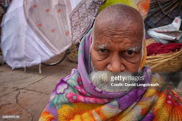 Hindu wandering holy man, known as a Sadhu, looks on from one of many religious shrines on the Ganges river. Throughout India, Sadhus practices a...