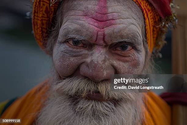 Hindu wandering holy man, known as a Sadhu, looks on from one of many religious shrines on the Ganges river. Throughout India, Sadhus practices a...