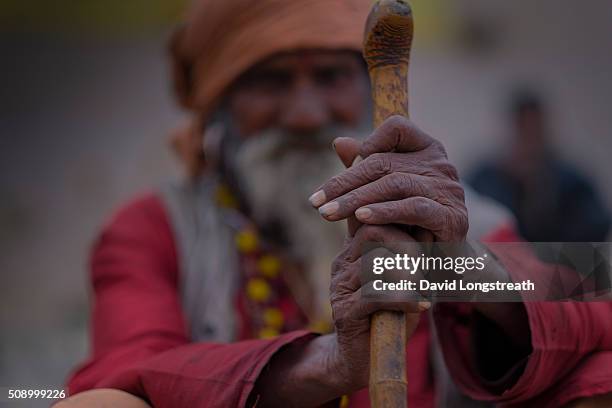 Hindu wandering holy man, known as a Sadhu, looks on from one of many religious shrines on the Ganges river. Throughout India, Sadhus practices a...