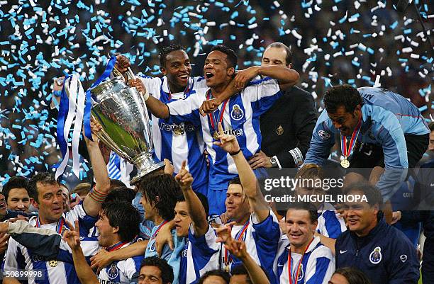 Germany: FC Porto's Benni McCarthy and Carlos Alberto hold the trophy as they celebrate with their teamates after beating Monaco 3-0 in the Champions...