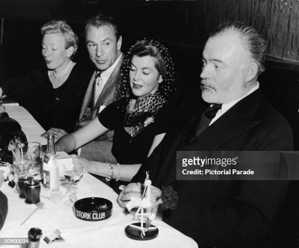 Martha Hemingway, actor Gary Cooper, his wife Veronica Balfe and author Ernest Hemingway sit in a booth at the Stork Club, New York City, 1943....
