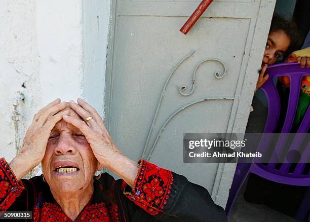 An elderly homeless Palestinian woman, Al-Hajja Fatma cries while sitting near her home which was destroyed by the Israeli Army in a recent raid May...