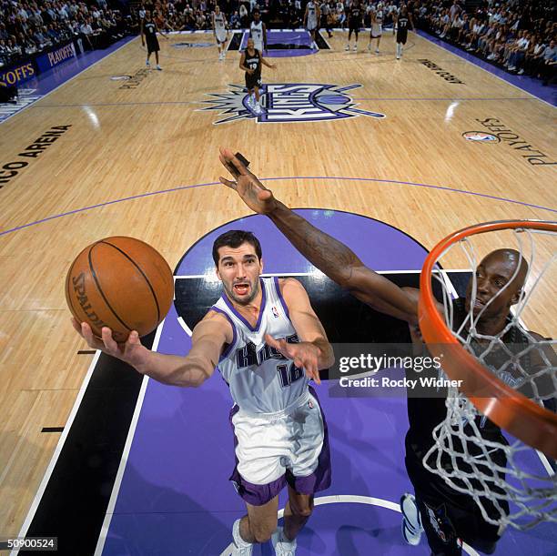 Predrag Stojakovic of the Sacramento Kings takes the ball up against Kevin Garnett of the Minnesota Timberwolves in Game Six of the Western...