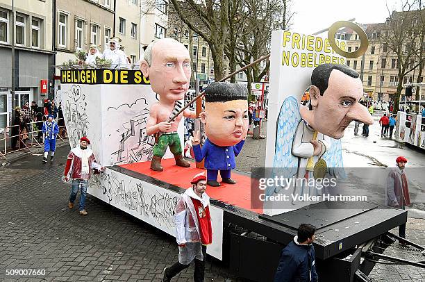 Slogan-bearing float featuring Vladimir Putin, Kim Jong-un and Bashar al-Assad makes its way through carnival revellers during the annual Rose Monday...