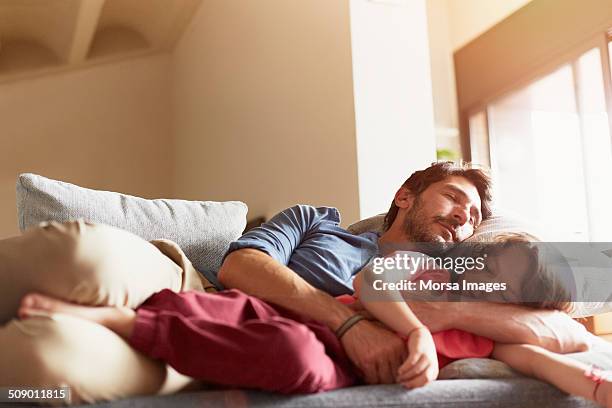 father and son sleeping on sofa - dormitar fotografías e imágenes de stock