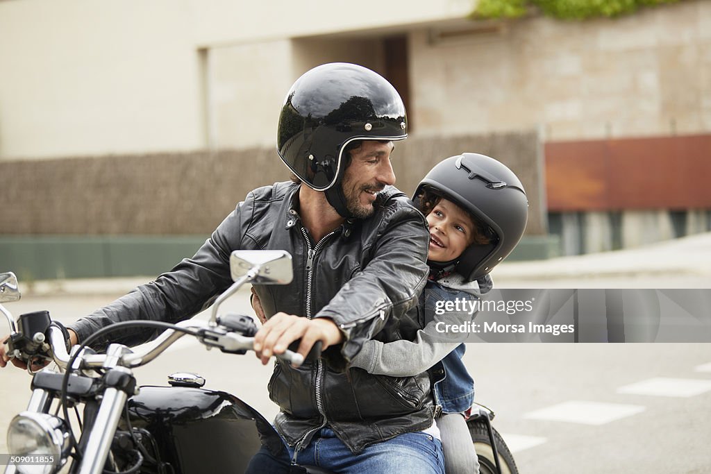 Father and son riding motorbike