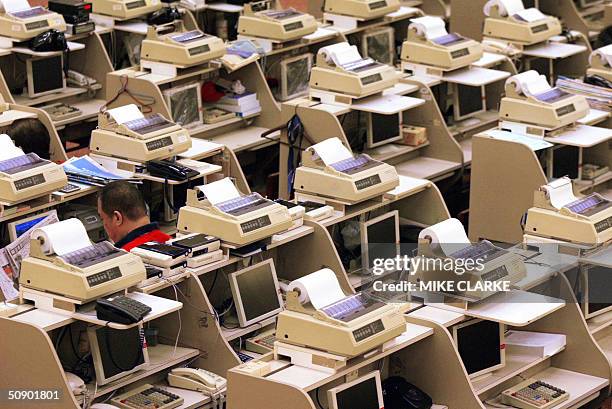 Traders on the floor of the Hong Stock Exchange in Hong Kong 27 May 2004. Hong Kong's key Hang Seng Index closed sharply higher 27 May, on hopes that...