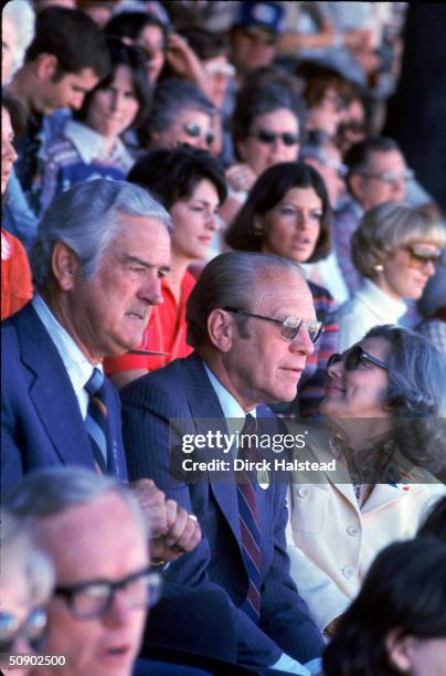 During his re-election campaign, American President Gerald Ford attends an event at the Cotton Bowl with former Texas governor John Connally and his...