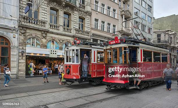 historical red trams on istiklal street in beyoglu - taksim square stock pictures, royalty-free photos & images