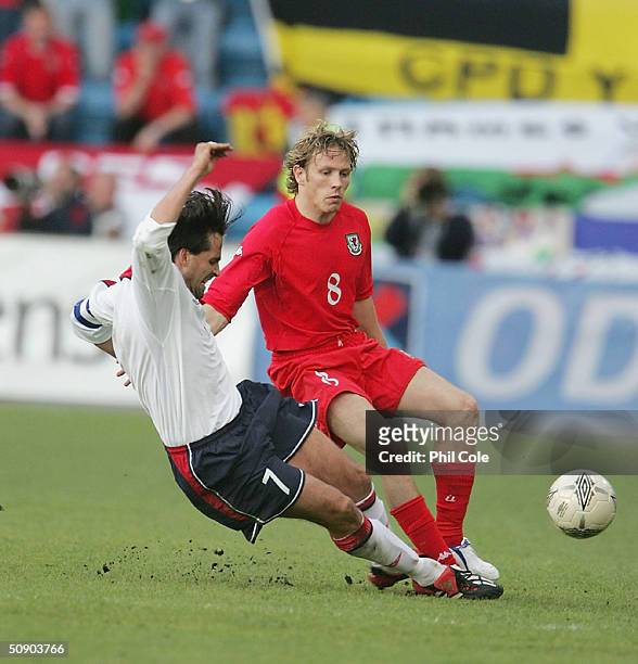 Martin Andresen of Norway goes in with a hard tackle on Craig Bellamy of Wales during the Norway v Wales Match at the Ullevaal Stadium in Oslo on May...