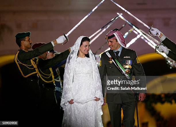 Crown Prince Hamzeh of Jordan and his bride Princess Noor smile during their wedding celebrations held May 27, 2004 in Amman, Jordan. Hamzeh and Noor...