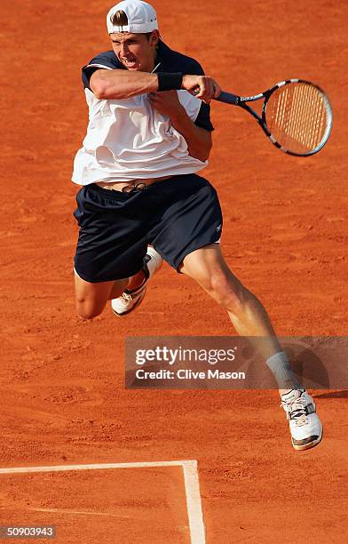 Igor Andreev of Russia returns in his second round match against Juan Carlos Ferrero of Spain during Day Four of the 2004 French Open Tennis...