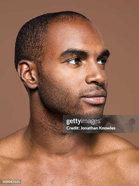 side portrait of a dark skinned male - halbbekleidet stock-fotos und bilder