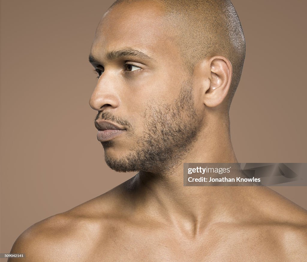 Portrait of a dark skinned male, looking away