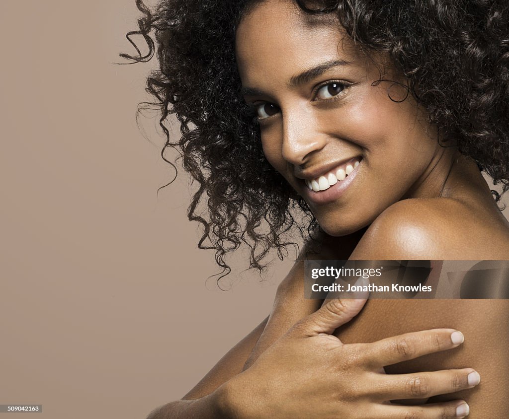 Side portrait of a dark skinned female, smiling