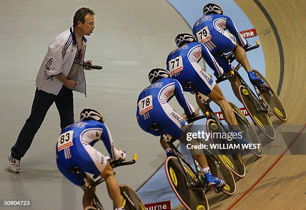 Coach Jacky Mourioux shouts times to the French team on their way to a shock defeat in the men's team pursuit qualifying session at the UCI Track...