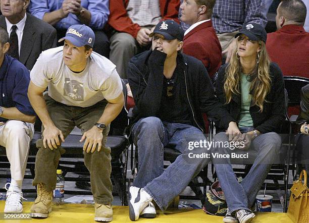: Actors Mark Walberg and Leonardo DiCaprio and girlfriend model Gisele Bundchen attend Game 4 of the NBA Western Conference Finals between the...