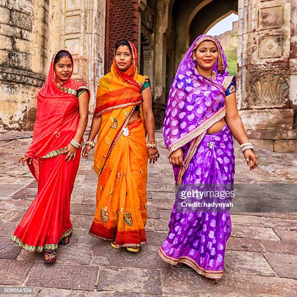 three indian women on the way to mehrangarh fort, india - meherangarh fort stock pictures, royalty-free photos & images