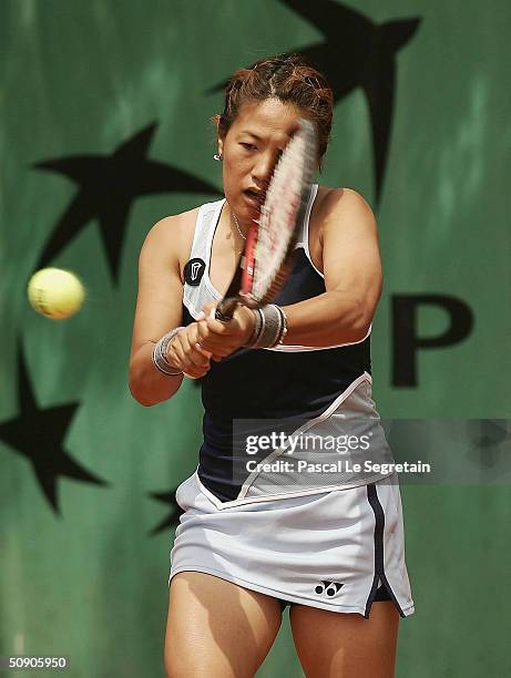 Rika Fujiwara of Japan returns in her second round doubles match with Shinobu Asagoe of Japan during Day Five of the 2004 French Open Tennis...