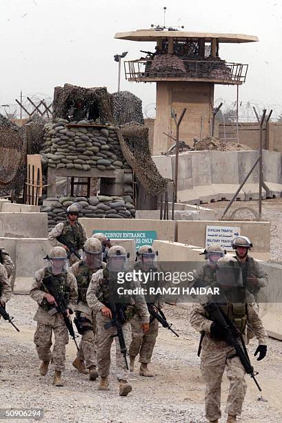 Troops are seen outside the Abu Ghraib prison, west of Baghdad, 28 May 2004, as some 600 Iraqi prisoners are released. US forces released a new wave...