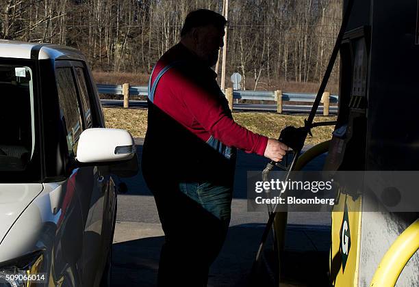 Customer prepares to pump fuel at a Go Mart Inc. Gas station in Rockbridge, Ohio, U.S., on Saturday, Feb. 6, 2016. Thanks to a glut of oil that has...