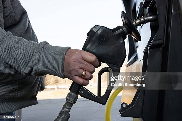 Customer prepares to pump fuel at a Go Mart Inc. Gas station in Rockbridge, Ohio, U.S., on Saturday, Feb. 6, 2016. Thanks to a glut of oil that has...