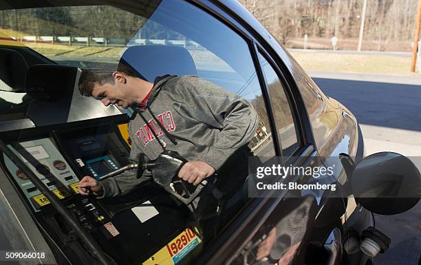 The reflection of a customer is seen on a the window of a vehicle at a Go Mart Inc. Gas station in Rockbridge, Ohio, U.S., on Saturday, Feb. 6, 2016....