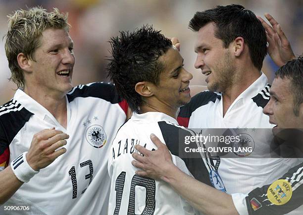 German Under-21 soccer players Bastian Schweinsteiger , Mimoun Azaouagh, Benjamin Auer and Christian Tiffert celebrate their 1-0 during their group B...