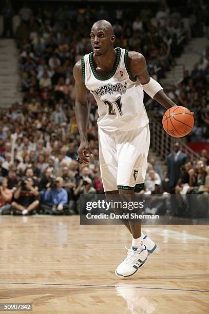 Kevin Garnett of the Minnesota Timberwolves dribble drives against the Sacramento Kings in Game Seven of the Western Conference Semifinals during the...