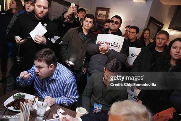 Customers eat their meals while surrounded by supporters of Republican presidential candidate Sen. Marco Rubio while he campaigns at the Village...