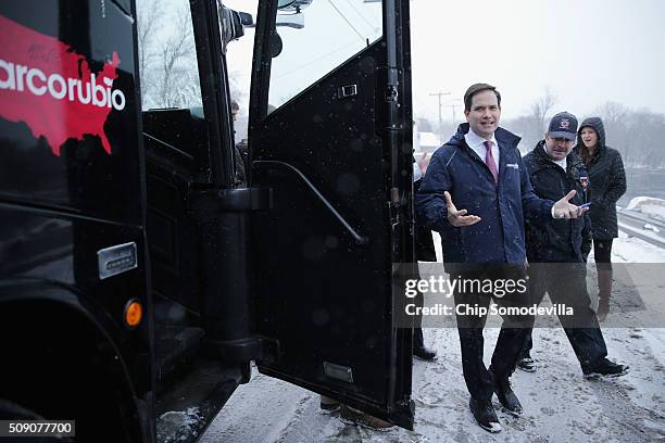 Republican presidential candidate Sen. Marco Rubio walks back to his campaign bus after visiting with customers at the Village Trestle restaurant...