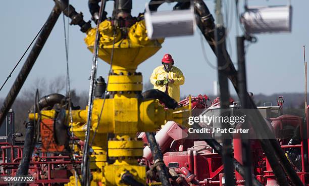 Halliburton oil well fielder works on a well head at a fracking rig site January 27, 2016 near Stillwater, Oklahoma.