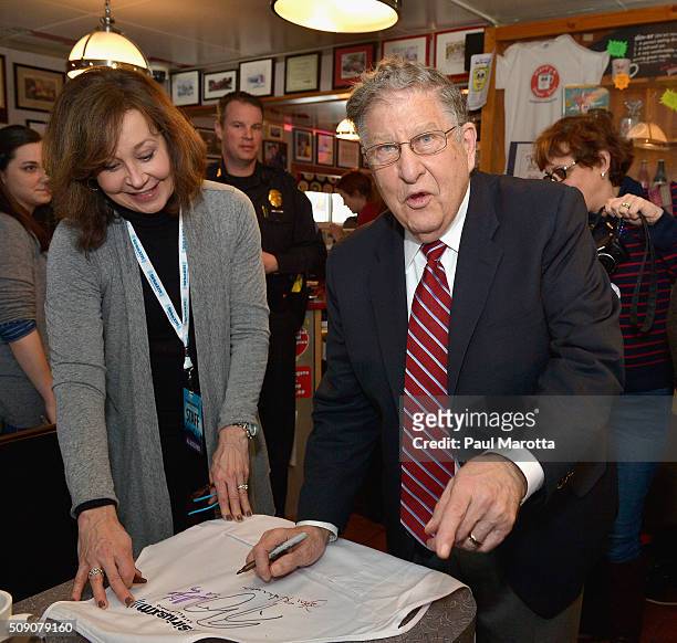 Former New Hampshire Governor John Sununu autographs a SiriusXM cooking apron at SiriusXM Broadcasts' New Hampshire Primary Coverage Live From Iconic...