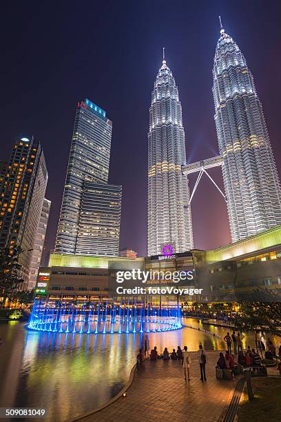 petrona towers overlooking crowds around illuminated fountains kuala lumpur malaysia - skybridge petronas twin towers stock pictures, royalty-free photos & images