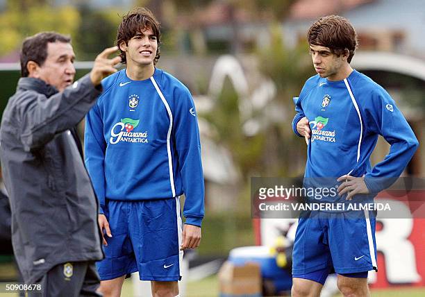 Brazilian coach Carlos Alberto Parreira , gives instructions to soccer players Kaka and Juninho Pernambucano during a training session in...