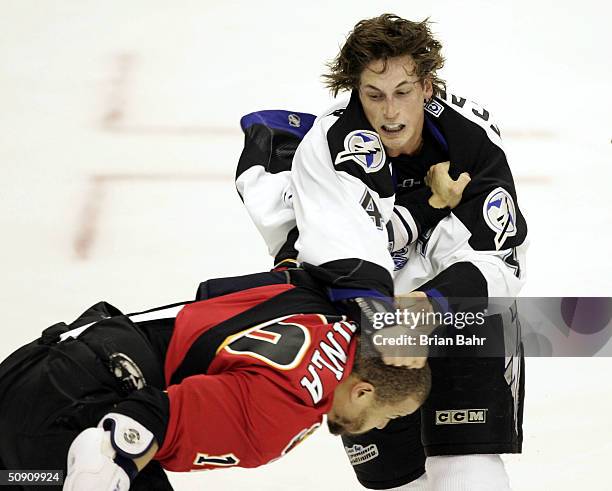 Vincent Lecavalier of the Tampa Bay Lightning throws a punch at Jarome Iginla of the Calgary Flames during a fight in the first period in game three...
