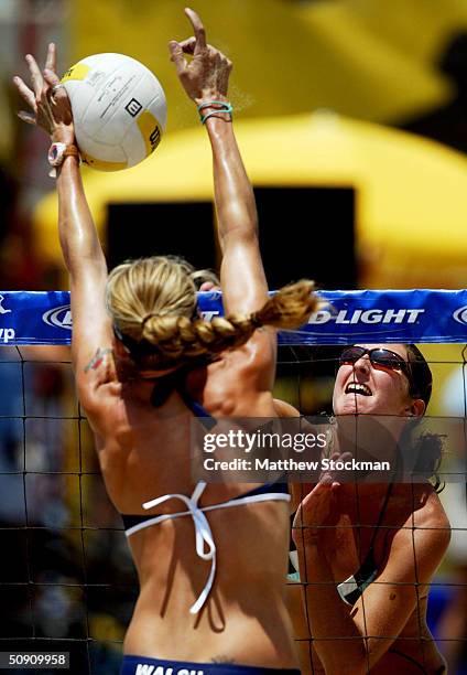 Kerri Walsh blocks a spike by Heather Lowe during the Bud Light Huntington Beach Open on May 29, 2004 in Huntington Beach, California.