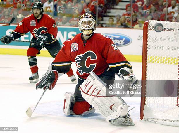 Miikka Kiprusoff of the Calgary Flames watches the puck skip through to the boards against the Tampa Bay Lightning in game three of the NHL Stanley...
