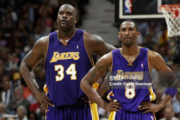 Shaquille O'Neal and Kobe Bryant of the Los Angeles Lakers stand on the court while playing againt the Minnesota Timberwolves in Game Five of the...