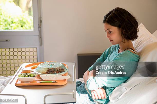 anorexia nervosa patient with a food tray in hospital ward - hospital food stock pictures, royalty-free photos & images